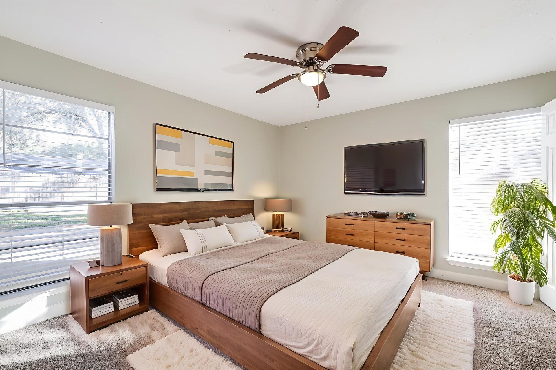 22826 Provincial Boulevard Katy, TX 77450 - Photo 10 of 18 a bedroom with a bed and a flat screen tv