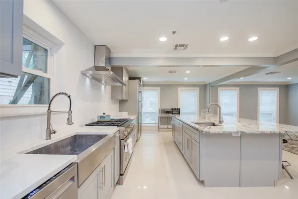 a kitchen with stainless steel appliances granite countertop a sink stove and cabinets