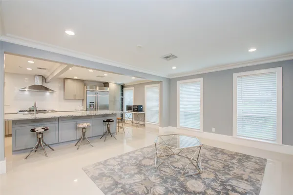 a living room with furniture a table and chair