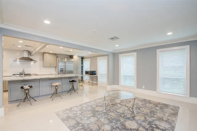 a living room with furniture a table and chair