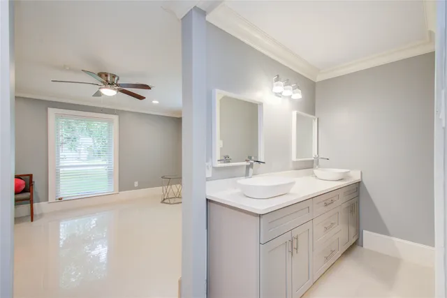 a bathroom with a double vanity sink and a mirror