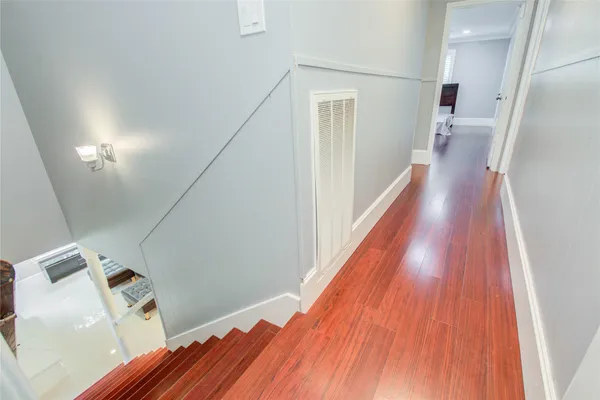 a view of hallway with wooden floor