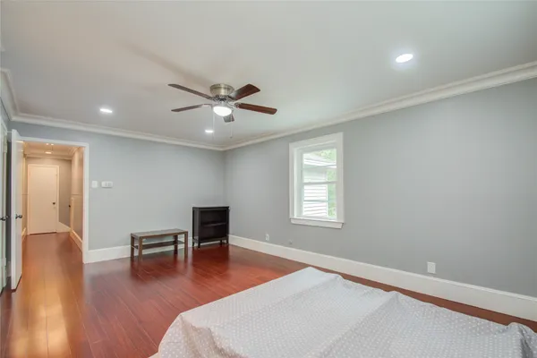 a living room with furniture and wooden floor next to a window