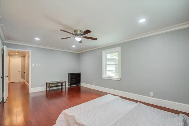 a living room with furniture and wooden floor next to a window