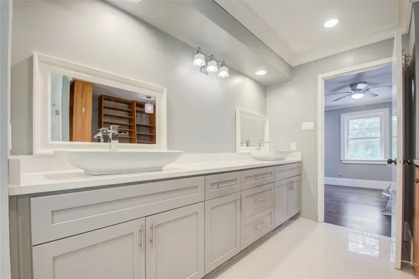 a bathroom with a sink a large mirror and a vanity