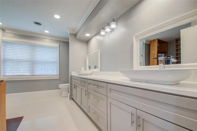 a bathroom with a sink a large mirror and a bathtub