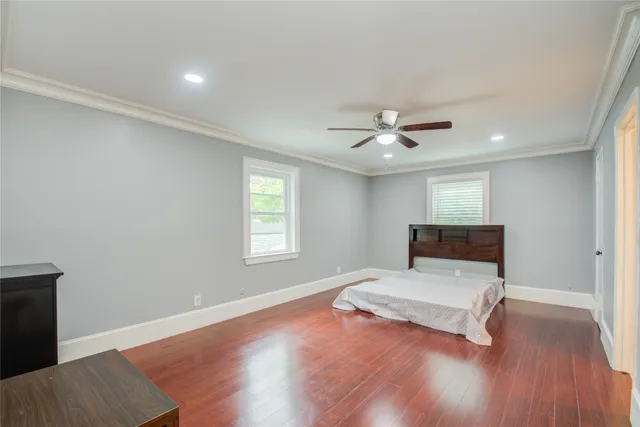 a white bedroom with a bed and window
