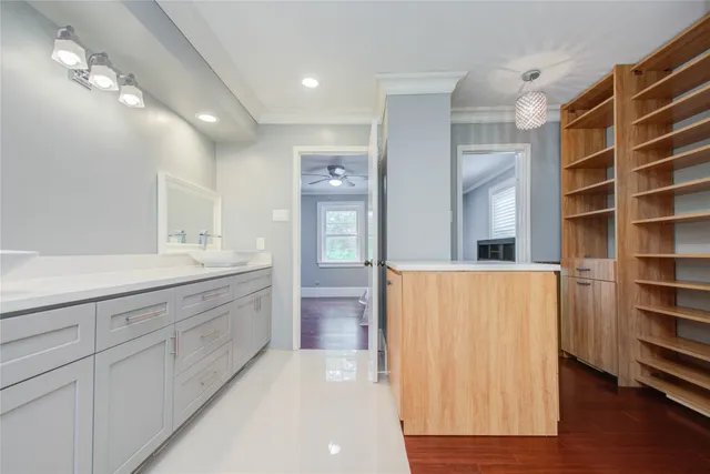 a spacious bathroom with a shower a sink and a large mirror