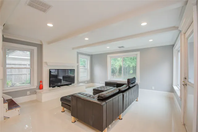 a living room with fireplace furniture and a window