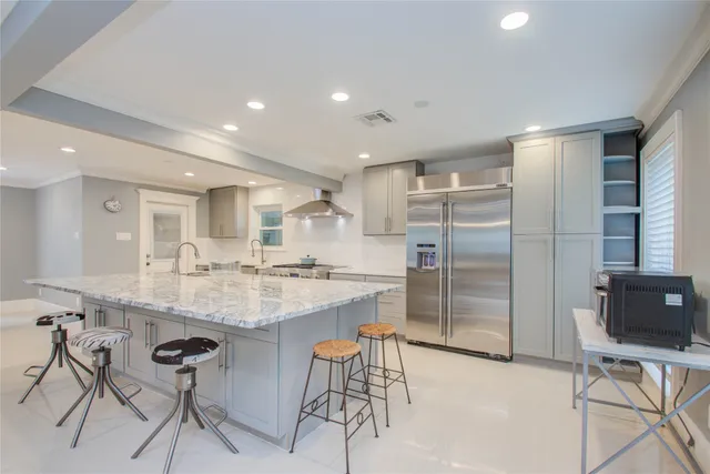 a kitchen with center island cabinets and stainless steel appliances