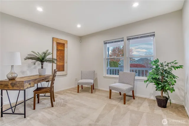 a living room with furniture and potted plant