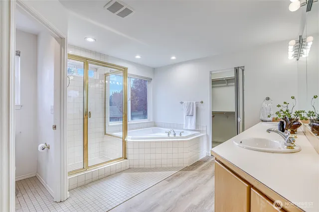 a bathroom with a tub sink and mirror