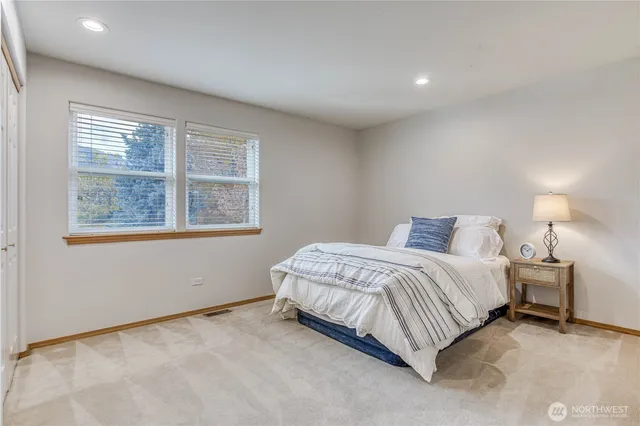 a spacious bedroom with a bed and a window
