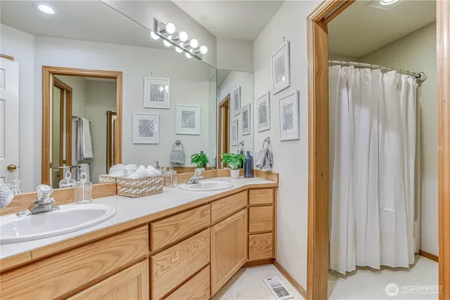 a bathroom with a double vanity sink and a mirror