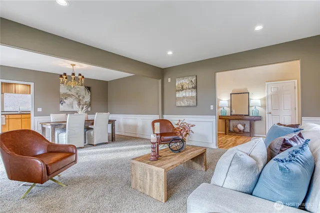 a living room with furniture and a chandelier