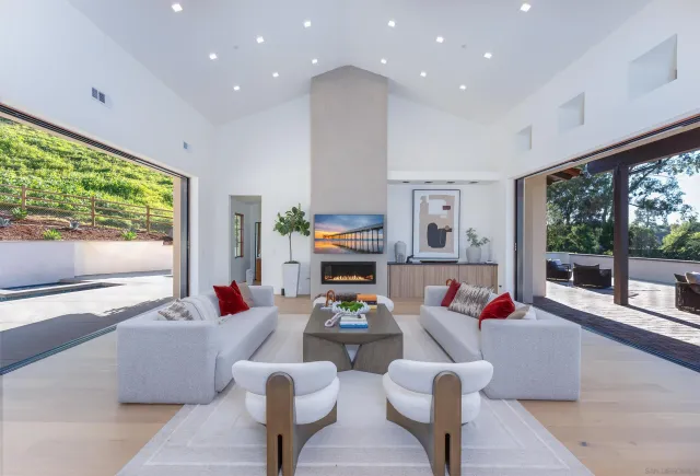 a spacious bedroom with a bed and large windows