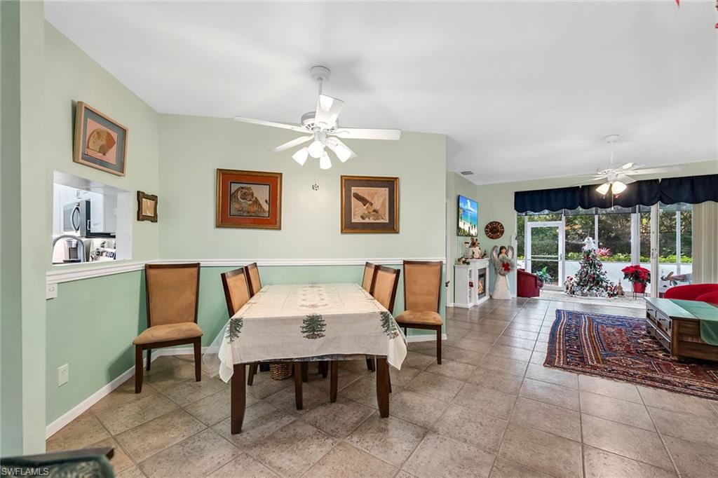 3755 Fieldstone Boulevard, Unit 1203 Naples, FL 34109 - Photo 12 of 50 a view of a dining room with furniture