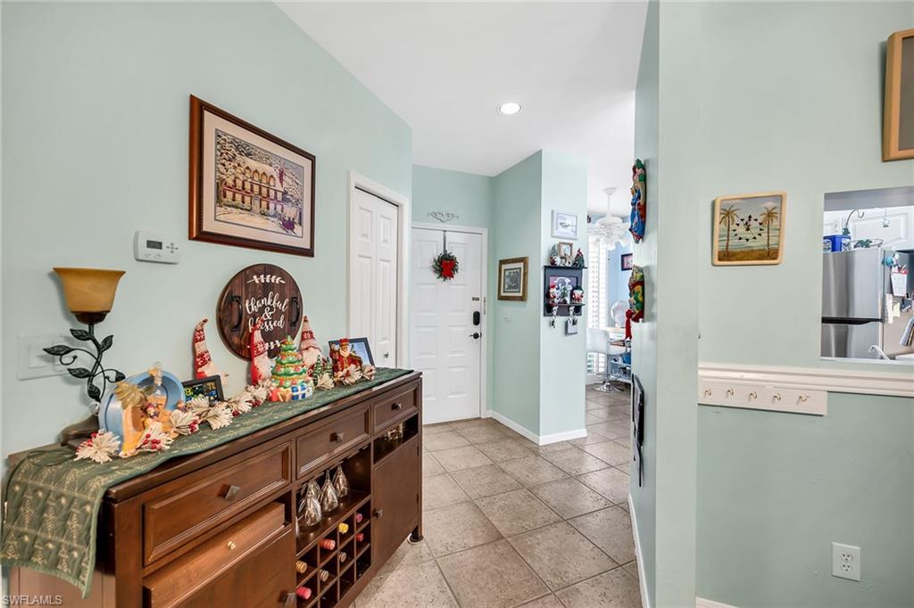 3755 Fieldstone Boulevard, Unit 1203 Naples, FL 34109 - Photo 23 of 50 a view of a kitchen with fridge and workspace