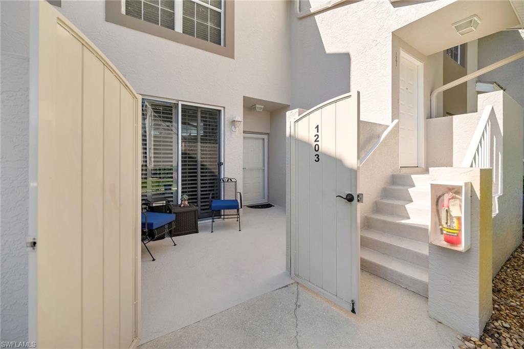 3755 Fieldstone Boulevard, Unit 1203 Naples, FL 34109 - Photo 31 of 50 a view of staircase with white walls and windows