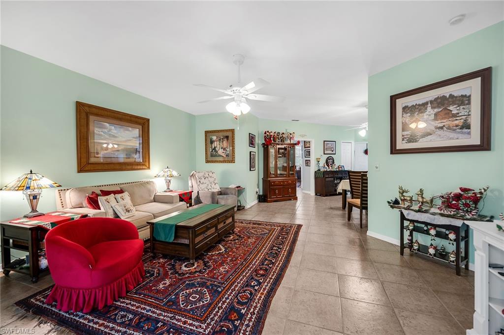 3755 Fieldstone Boulevard, Unit 1203 Naples, FL 34109 - Photo 8 of 50 a living room with furniture and wooden floor