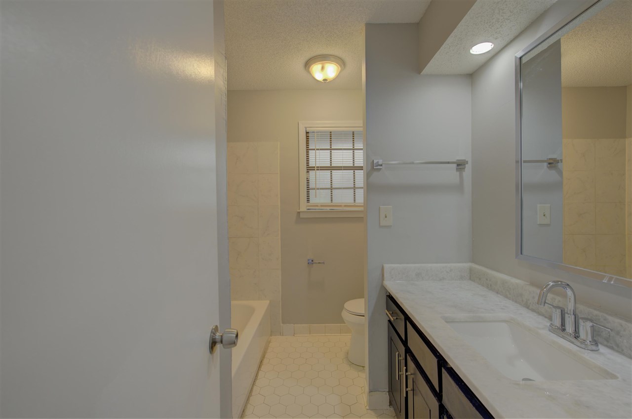 7024 Rockingham Road Memphis, TN 38125 - Photo 12 of 18 a bathroom with a granite countertop sink and shower