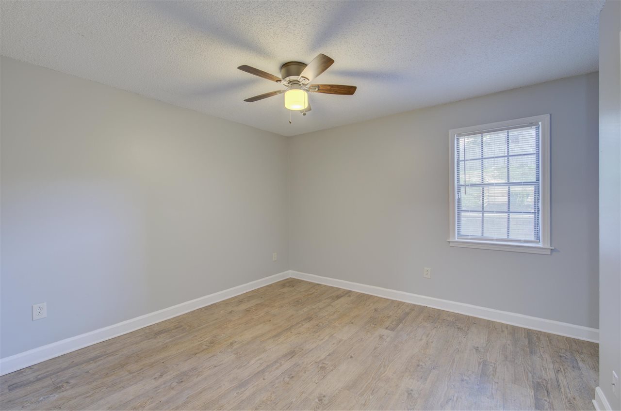 7024 Rockingham Road Memphis, TN 38125 - Photo 13 of 18 wooden floor in an empty room with a window