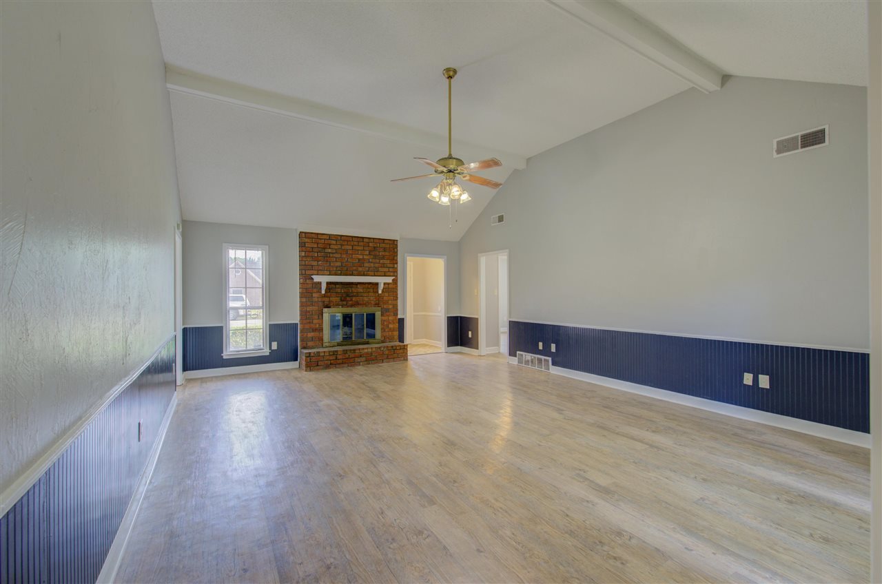 7024 Rockingham Road Memphis, TN 38125 - Photo 4 of 18 a view of empty room with wooden floor and fireplace