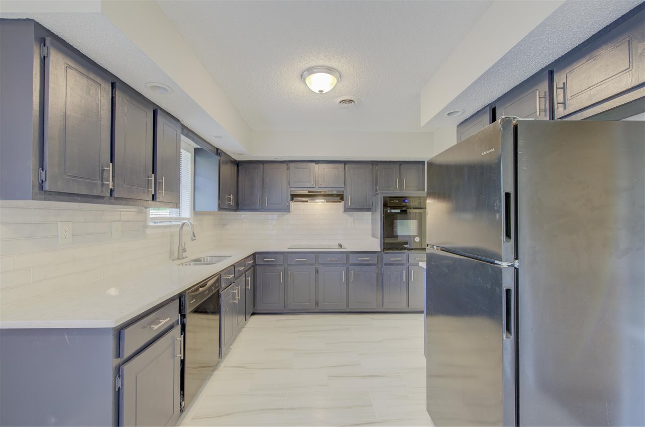 7024 Rockingham Road Memphis, TN 38125 - Photo 5 of 18 a kitchen with stainless steel appliances granite countertop a refrigerator and a sink