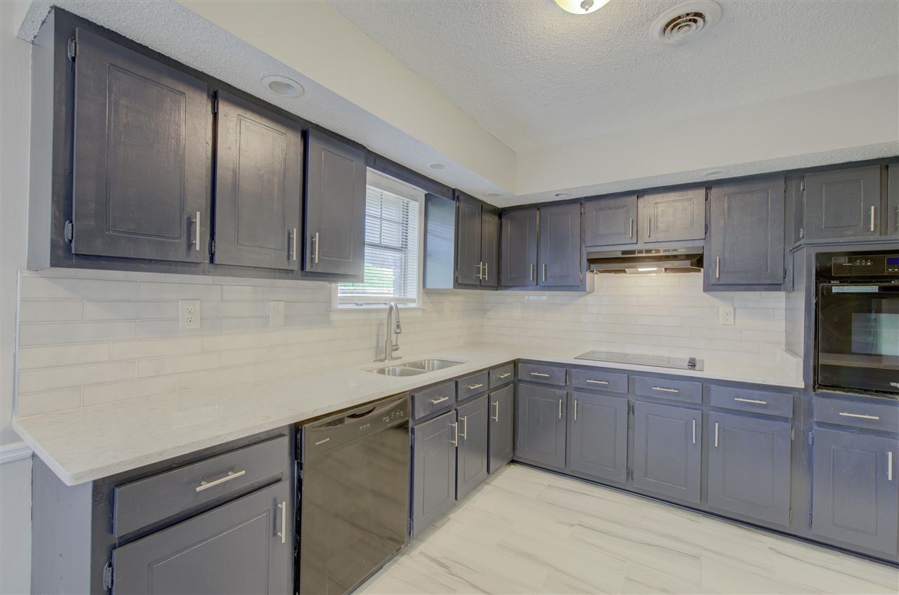 7024 Rockingham Road Memphis, TN 38125 - Photo 6 of 18 a kitchen with a sink and cabinets
