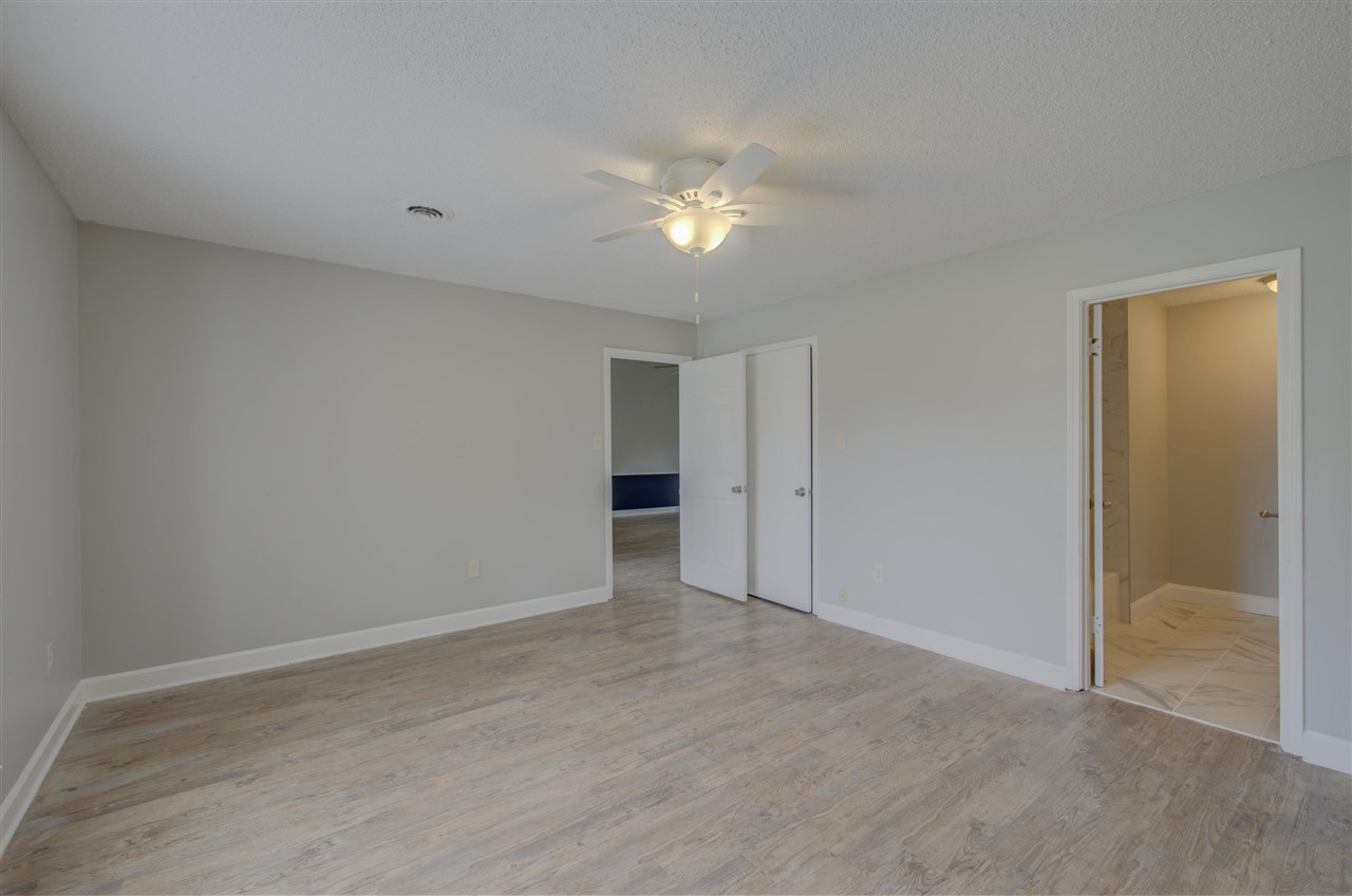 7024 Rockingham Road Memphis, TN 38125 - Photo 8 of 18 a view of an empty room with a fan