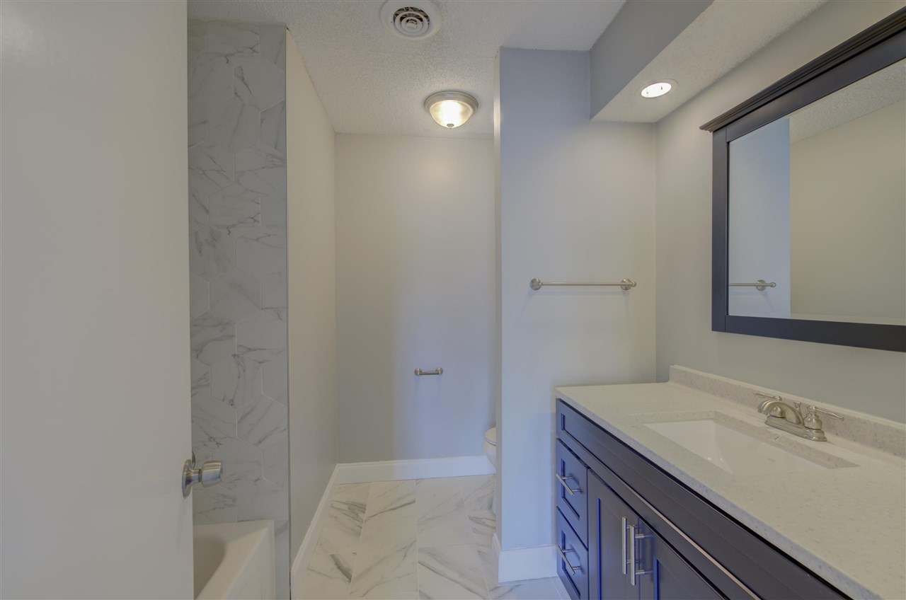 7024 Rockingham Road Memphis, TN 38125 - Photo 9 of 18 a bathroom with a sink and a mirror