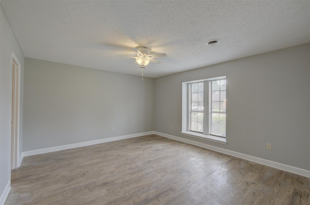 7024 Rockingham Road Memphis, TN 38125 - Photo 10 of 18 a view of empty room with wooden floor and fan
