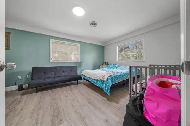 a bedroom with a bed and a chandelier