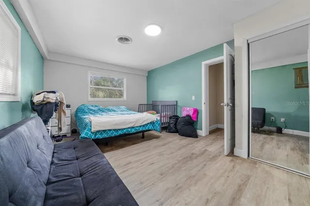 a en suite bathroom with a granite countertop sink and a mirror
