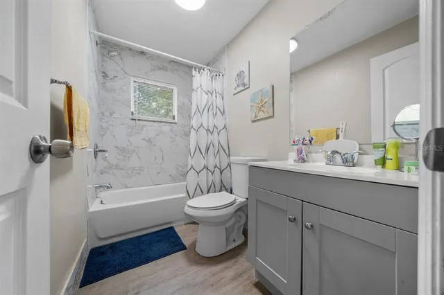 a view of a hallway to a livingroom and wooden floor