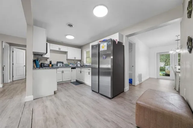 a kitchen with granite countertop a sink a stove and cabinets