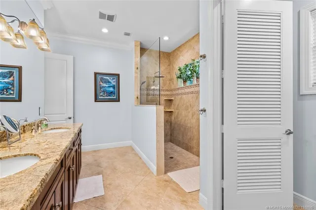 a bathroom with a granite countertop sink toilet and mirror