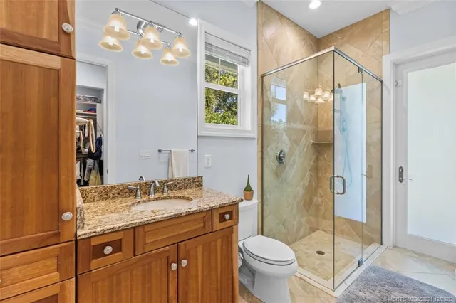 a living room with furniture a large window and wooden floor