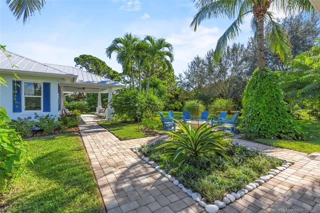 a view of a patio with a dining table and chairs