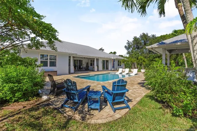 a view of a patio with couches chairs and a big yard