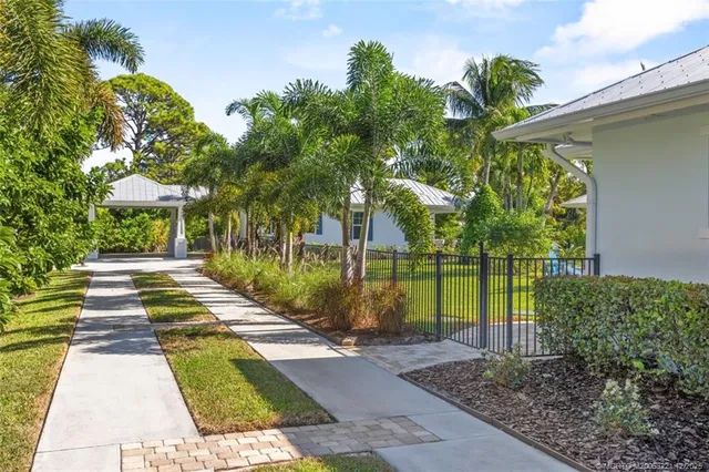 an aerial view of residential house with outdoor space and trees all around