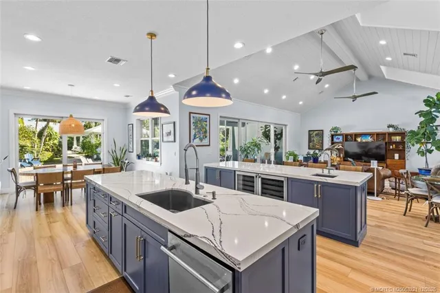 a large kitchen with stainless steel appliances kitchen island granite countertop a large center island and a stove