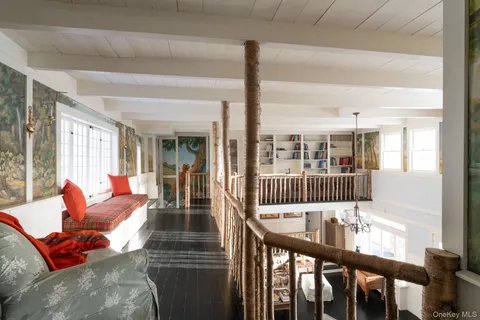 a view of a living room and furniture in wooden floor
