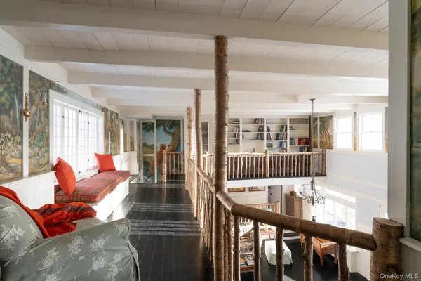 a view of a living room and furniture in wooden floor