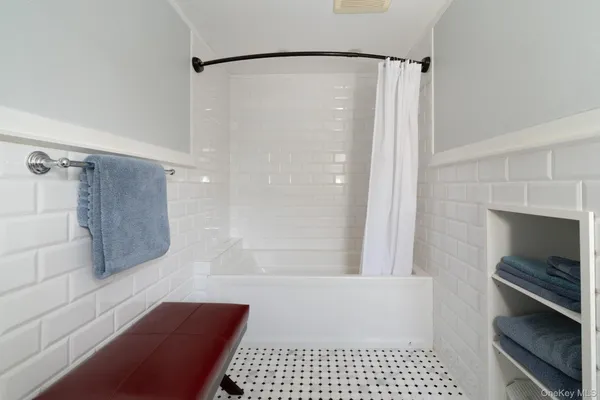 a bathroom with a bathtub and a shower
