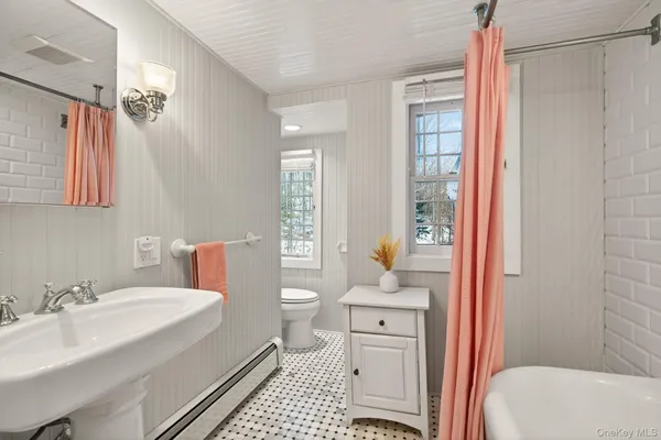 a bathroom with a sink toilet vanity and shower