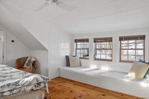 a bedroom with a large bed and a window