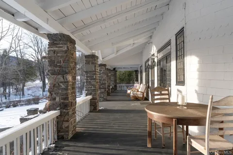 a view of a patio with table and chairs and wooden floor