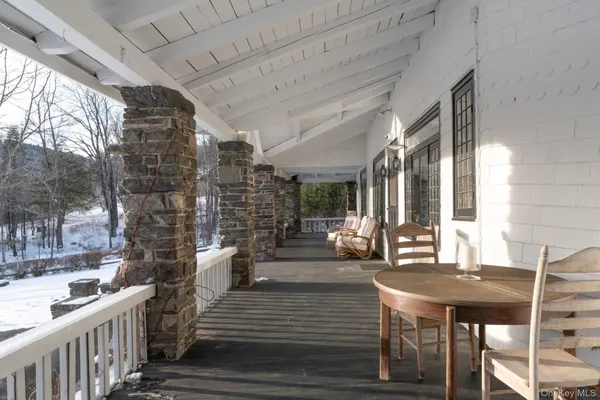 a view of a patio with table and chairs and wooden floor