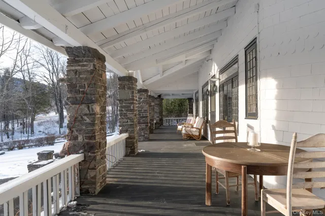 a view of a patio with table and chairs and wooden floor